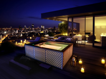 Petite Source finition Nid d'étoiles - Spa design lumineux Installé hors-sol sur la terrasse d'un appartement moderne avec vue sur la ville de nuit.